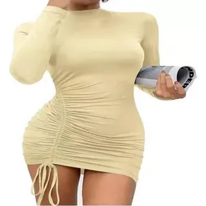Detail view of a cream long-sleeve ruched mini dress with side drawstring design