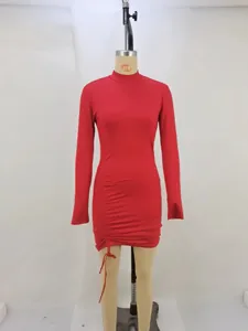 Detail view of a red high-neck long sleeve dress with adjustable side ruching and drawstring tie.