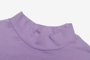 Close-up of the elegant mock neck detail on a purple long sleeve ruched dress fabric