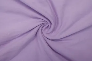 Close-up macro detail showing the soft purple knit fabric texture and drape of the dress