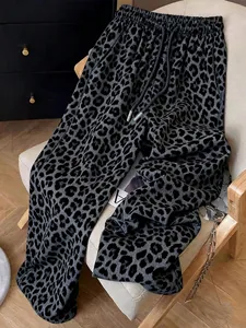 Close-up view of grey leopard print casual sweatpants displayed on a stylish chair
