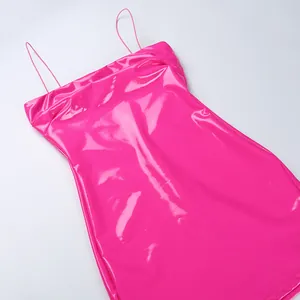 Close-up of glossy pink PU leather material on a sexy spaghetti strap mini dress
