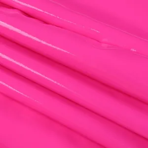 Close-up detail showing the glossy texture and fold of hot pink PU leather fabric