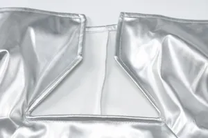 Close-up of the silver PU leather texture and stitching on a sexy cutout dress