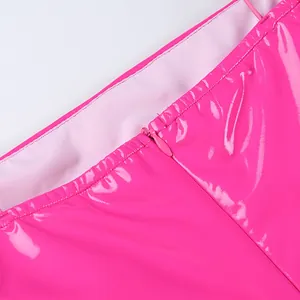 Detailed macro shot showing the hidden zipper on a hot pink shiny PU leather bodycon dress