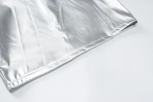 Close-up detail view of silver metallic PU leather fabric showing the neat hem stitching line