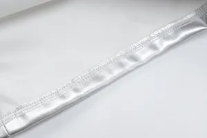 Macro detail showing the high-quality stitching and silver metallic PU leather texture