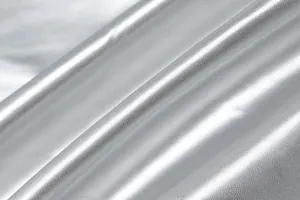 Close-up detail of metallic silver PU leather fabric with a textured pebbled surface.