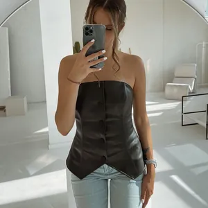 Detail of sexy black faux leather strapless corset top with button-up front
