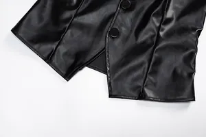 Detail view of black PU leather bandeau top with button closure and hem stitching.