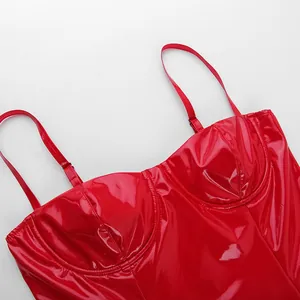 Detail of shiny red PU mini dress showing bust structure and thin straps.