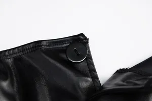 Close-up detail of a black PU leather tube top featuring a sleek smooth round button.