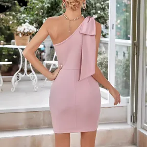 Detailed back view of an elegant pink one-shoulder bodycon dress with bow detail