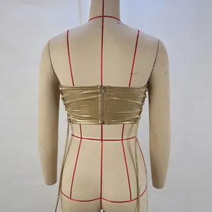 Back view of gold metallic corset top with zipper and lace-up sides on mannequin