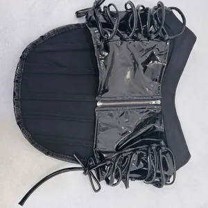Detail view of a black patent leather corset top with side lacing and zipper.