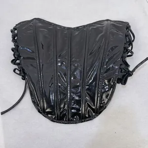 Close-up of sexy black shiny vinyl corset top with adjustable lace-up sides and fishbone
