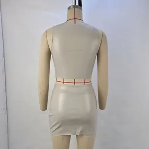 Back view of beige PU leather two-piece set with tank top and mini skirt.