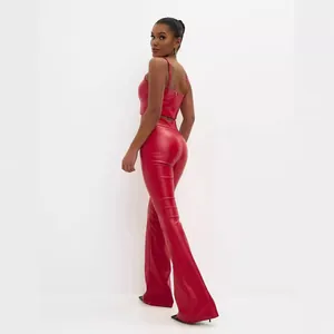 Stylish red faux leather two-piece set featuring high-waist flared pants and crop top