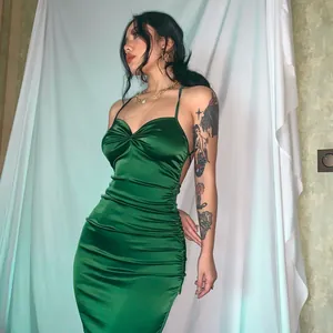 Elegant emerald green satin maxi dress featuring a slim-fit ruched silhouette.