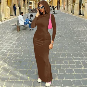 Elegant brown slim fit hooded maxi dress shown in a stylish outdoor street setting