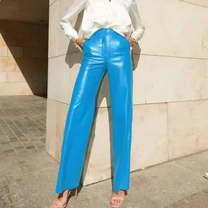 Vibrant blue PU leather straight leg trousers for women in a street style shot
