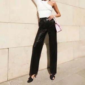 Detailed shot of high-waist black PU leather straight-leg pants with premium texture.