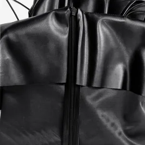 Close-up detail of the back zipper and ruffled texture on a black PU leather dress
