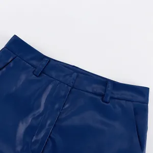 Close-up of deep blue PU leather pants waistband with belt loops and pocket detail