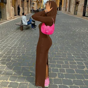 Side profile showing the fit of a brown hooded bodycon maxi dress in a street setting.