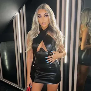 Detail view of a black halter neck PU mini dress with sexy cut-out bust design