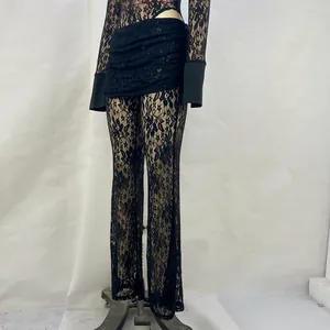 Nahaufnahme einer eleganten schwarzen Schlaghose aus floraler Spitze mit hoher Taille