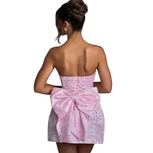 Elegant pink jacquard tube top mini dress featuring a large decorative back bow and lace-up