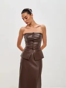 Close-up detail of a brown PU leather strapless tube top with button-down and peplum hem