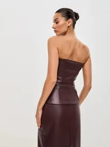 Back view of a dark burgundy PU leather strapless corset top on a model