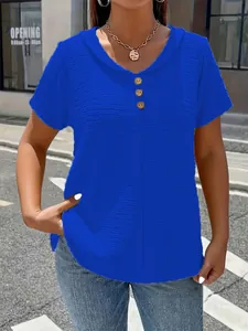 Detailed macro view showing the royal blue textured fabric and buttons on a V-neck T-shirt