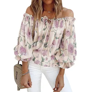 Close-up detail of off-the-shoulder floral chiffon blouse with elegant ruffled sleeves.