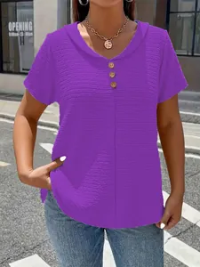 Close-up of women's purple textured V-neck T-shirt with decorative buttons.
