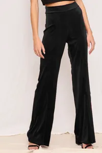 Detailed view of high-waisted black velvet wide-leg pants on a model fit profile