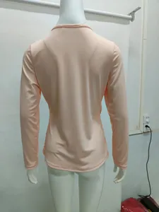 Detailed back view of women's slim fit peach ribbed long sleeve knit top on mannequin
