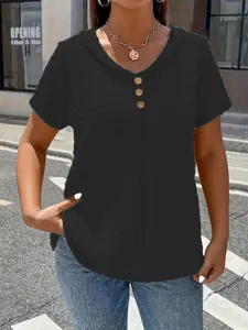 Detail of women's black V-neck t-shirt with wooden buttons and textured fabric.