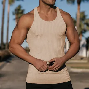 Macro detail view of men's ribbed knit racerback fitness tank top in beige color