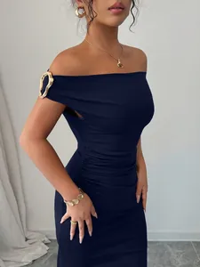 Elegant navy blue off-the-shoulder bodycon dress with chic gold buckle strap detail