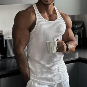 Detailed shot of a white ribbed slim fit gym tank top on a muscular fitness model.
