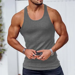 Detailed view of grey ribbed racerback tank top showing the slim fit on a muscular build