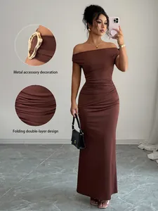 Brown off-the-shoulder maxi dress featuring ruched details and gold metal accessory