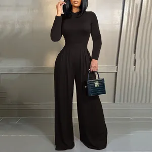 Professional fashion photo of an elegant black long sleeve jumpsuit with high waist and wide leg
