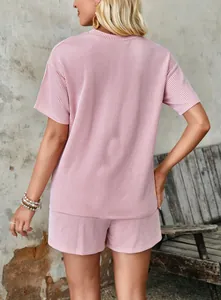 Back view of pink wavy textured 2-piece set with short sleeve top and shorts
