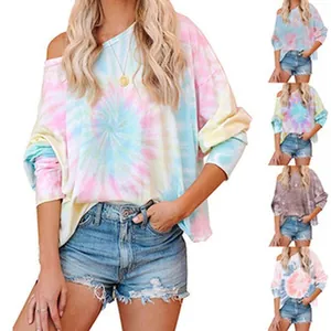 Detail view of colorful tie-dye off-shoulder long sleeve top with relaxed fit and denim shorts