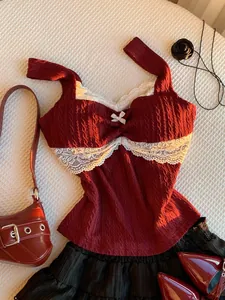 Detail view of a burgundy Y2K style tank top featuring white lace trim and a cute bow