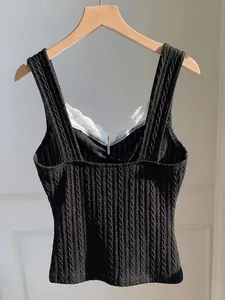 Detail view of Y2K black cable knit camisole with delicate white lace trim and slim fit design